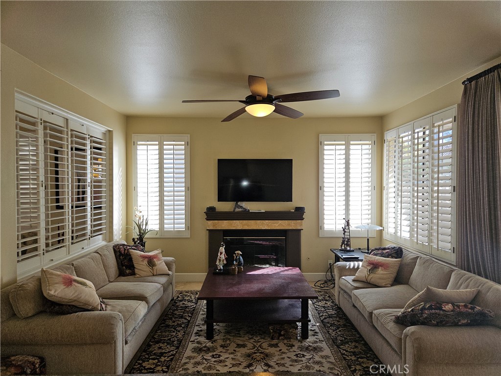 12924 Maxwell Drive Tustin, CA 92782 - Photo 4 of 8 a living room with furniture a flat screen tv and a fireplace