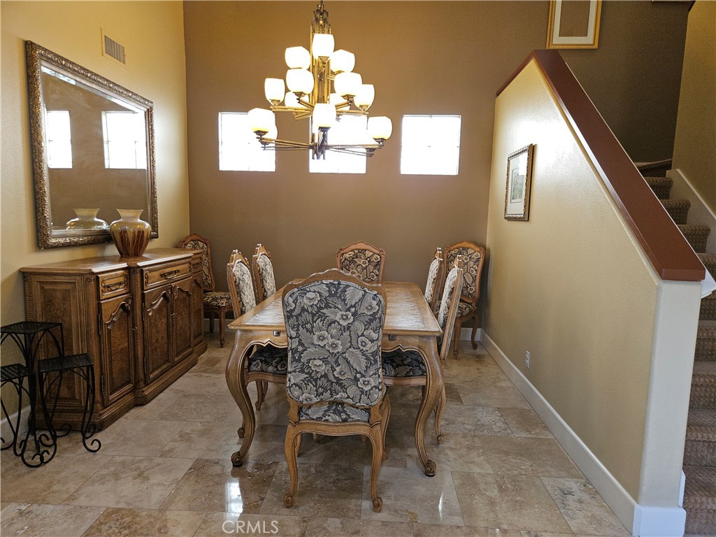 12924 Maxwell Drive Tustin, CA 92782 - Photo 5 of 8 a view of a dining room with furniture and chandelier