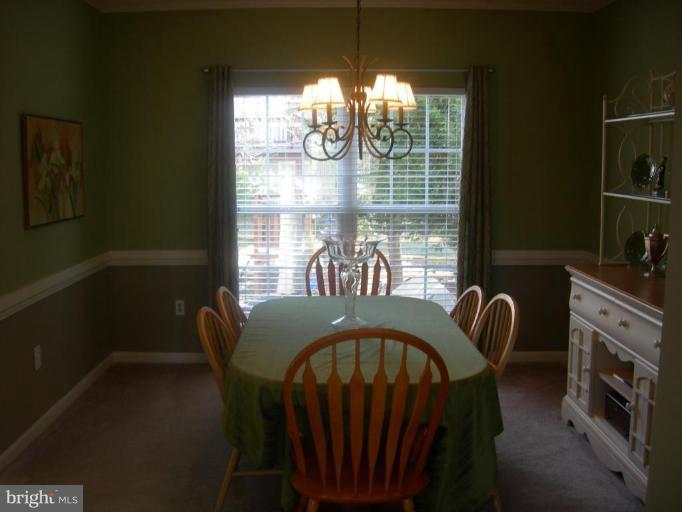 46815 Willowood Place Sterling, VA 20165 - Photo 2 of 22 a view of a dining room with furniture window and outside view