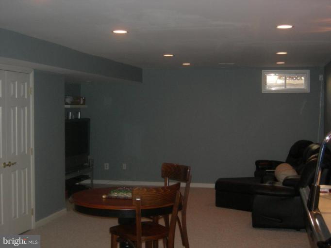 46815 Willowood Place Sterling, VA 20165 - Photo 14 of 22 a living room with furniture and a chandelier