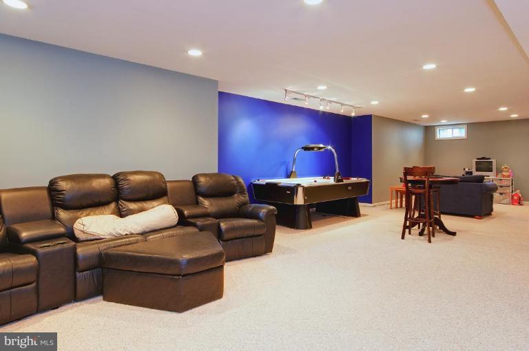 46815 Willowood Place Sterling, VA 20165 - Photo 17 of 22 a living room with furniture and a flat screen tv