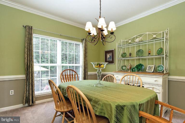 46815 Willowood Place Sterling, VA 20165 - Photo 18 of 22 a view of a dining room with furniture and a window
