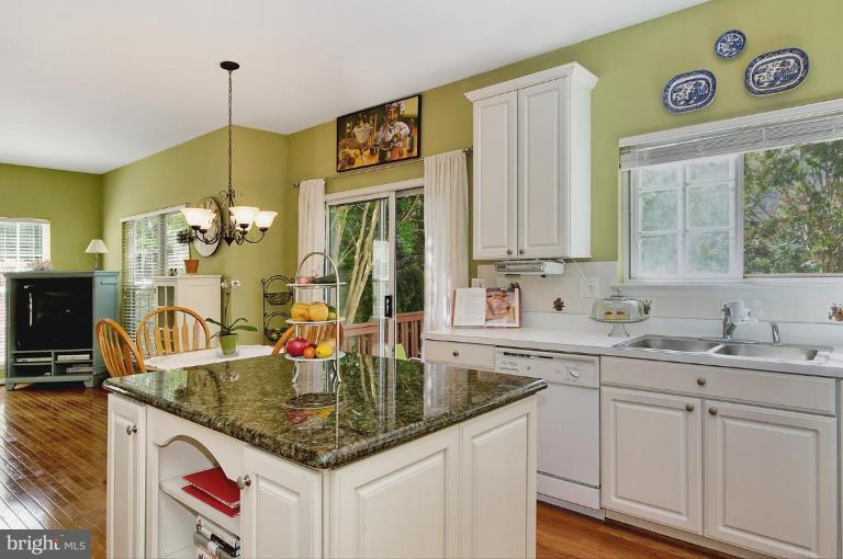 46815 Willowood Place Sterling, VA 20165 - Photo 20 of 22 a kitchen with kitchen island a sink and a refrigerator
