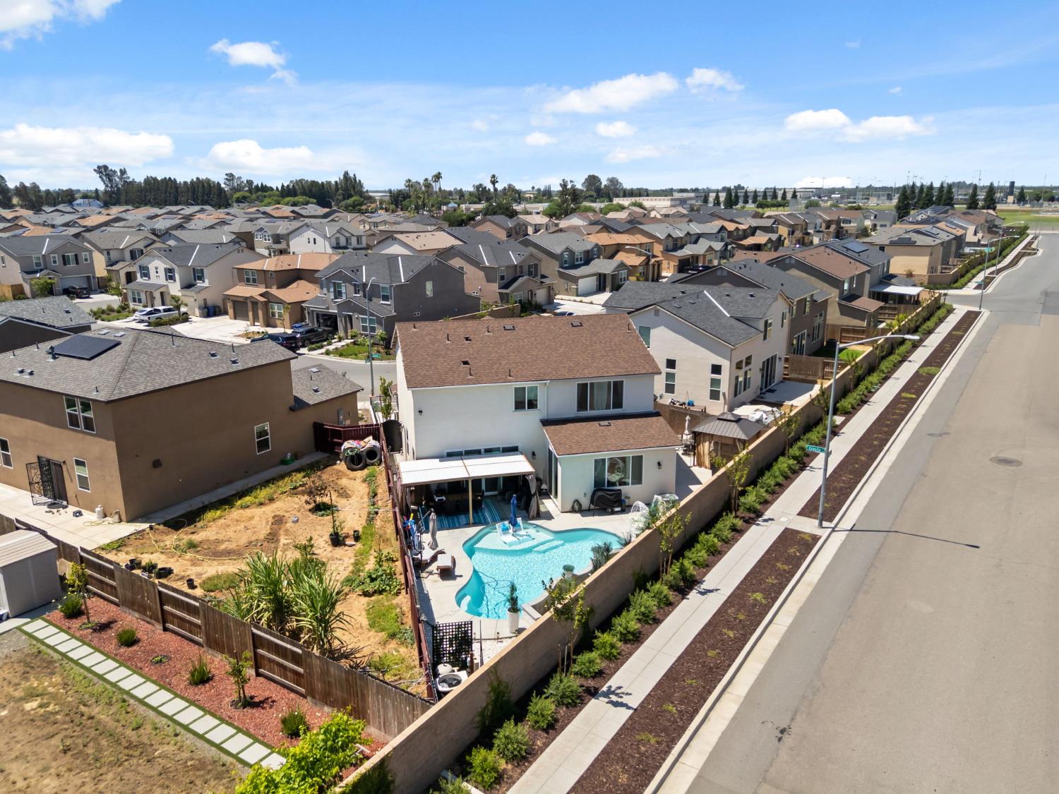 6326 West Richert Avenue Fresno, CA 93723 - Photo 42 of 45 an aerial view of a residential apartment building with a yard