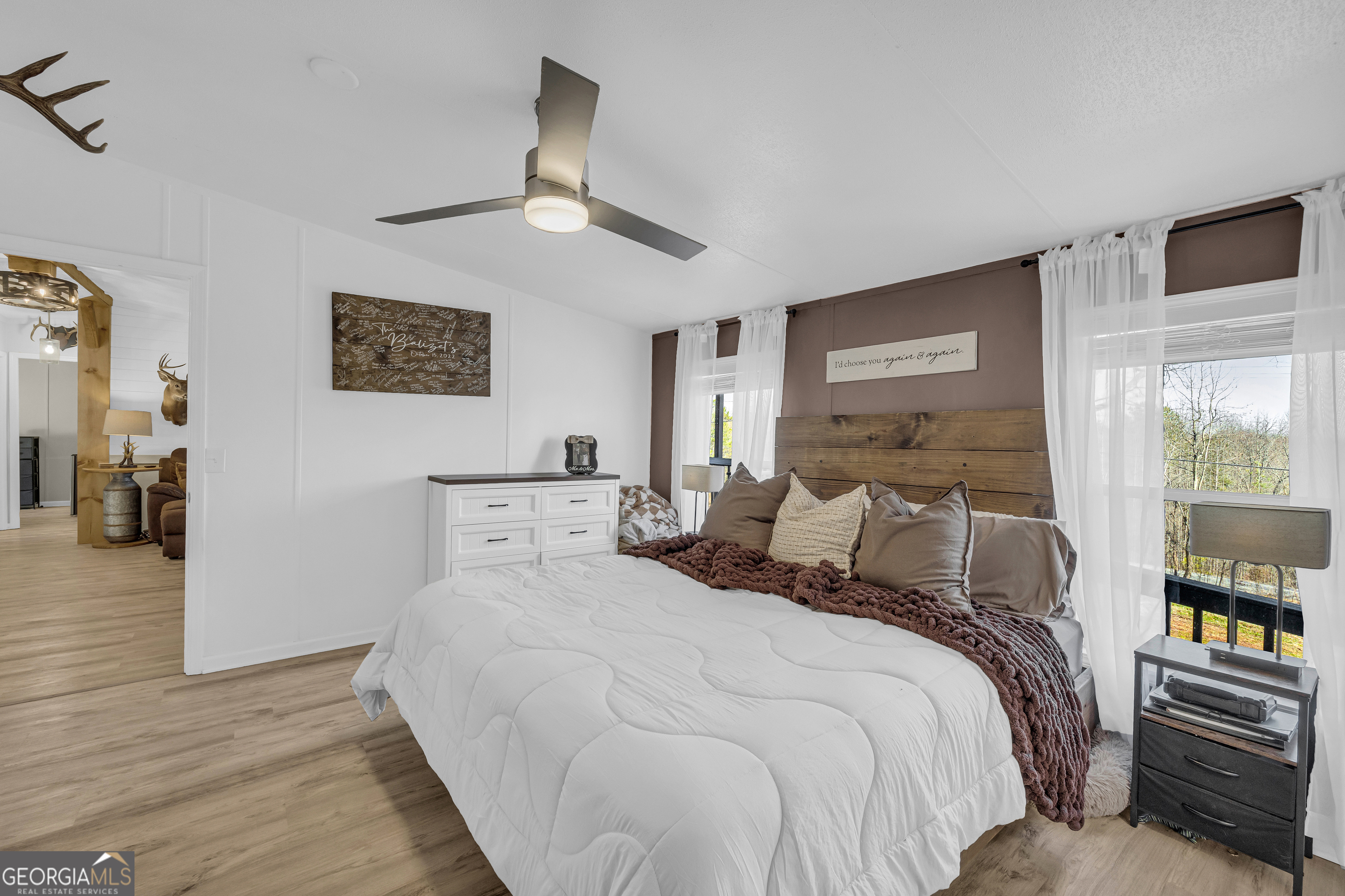 3656 Candler Road Pendergrass, GA 30567 - Photo 11 of 34 a bedroom with a large bed and a tv