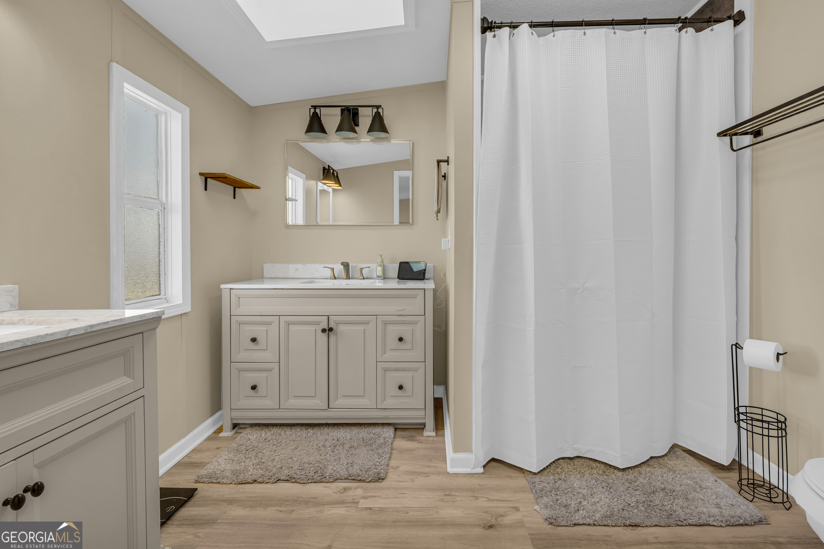 3656 Candler Road Pendergrass, GA 30567 - Photo 13 of 34 a bathroom with a sink and a mirror