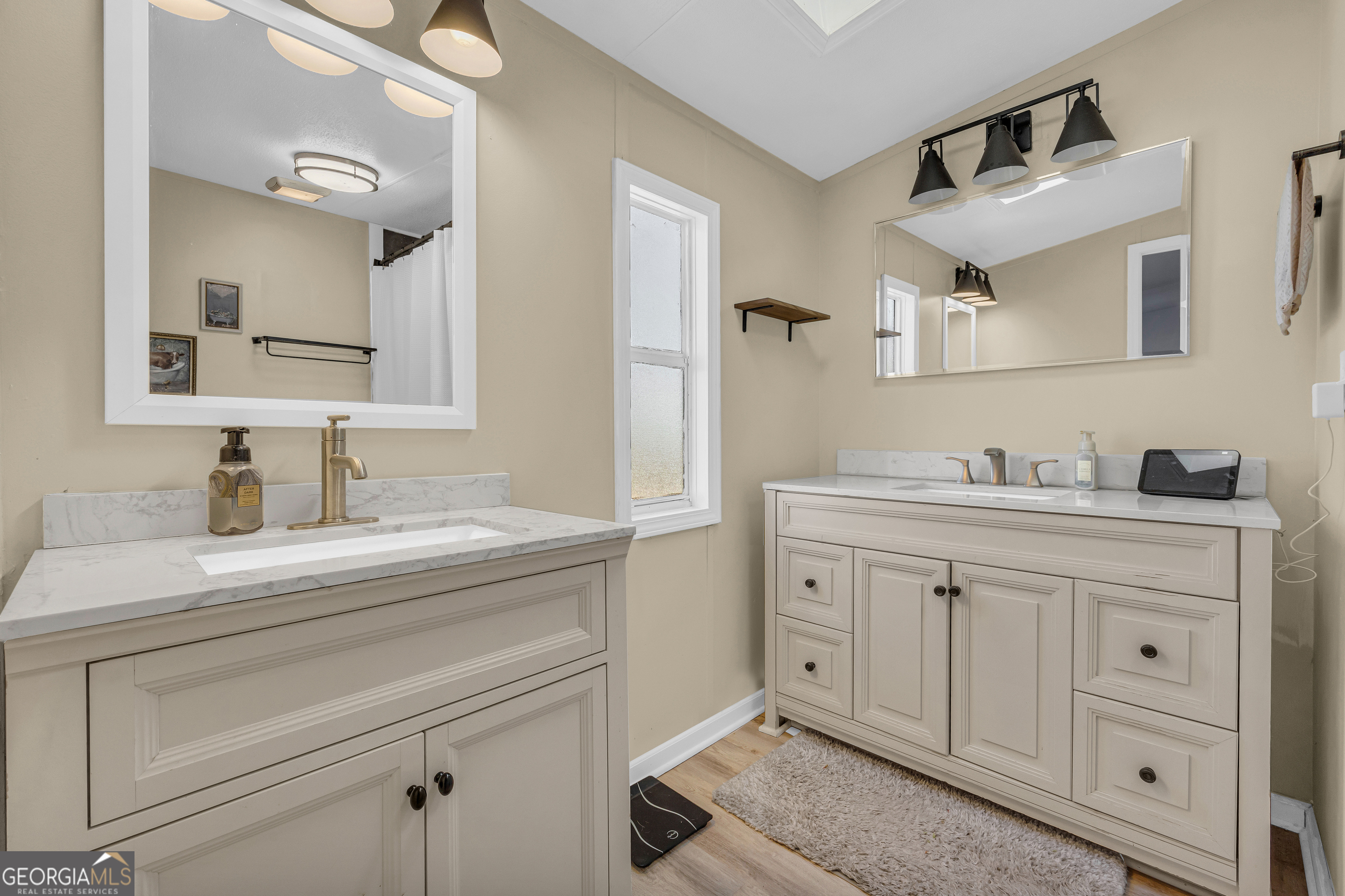 3656 Candler Road Pendergrass, GA 30567 - Photo 14 of 34 a spacious bathroom with a granite countertop sink and a mirror