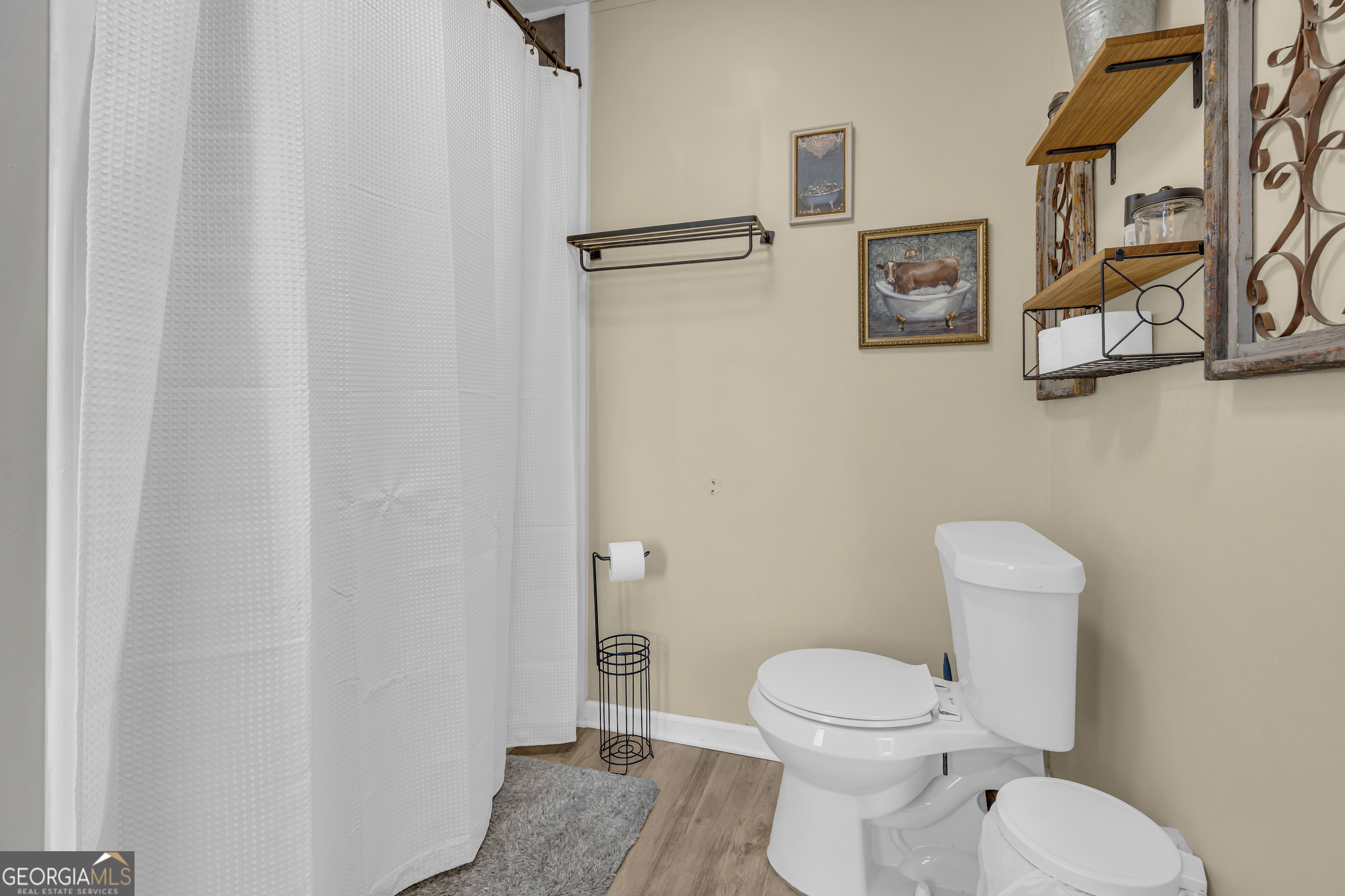 3656 Candler Road Pendergrass, GA 30567 - Photo 15 of 34 a white toilet sitting next to a bathroom sink