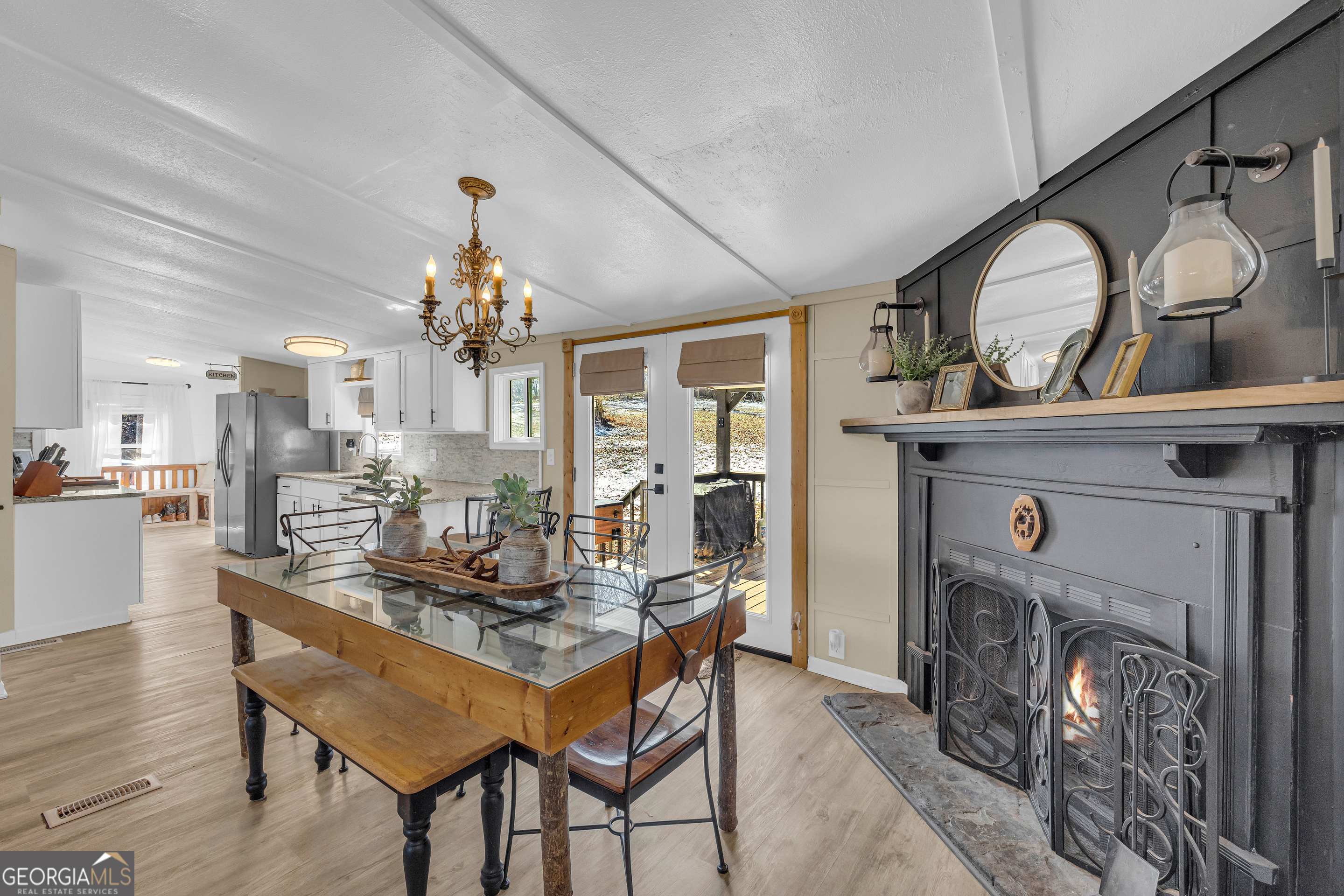 3656 Candler Road Pendergrass, GA 30567 - Photo 17 of 34 a dining room with furniture and a fireplace
