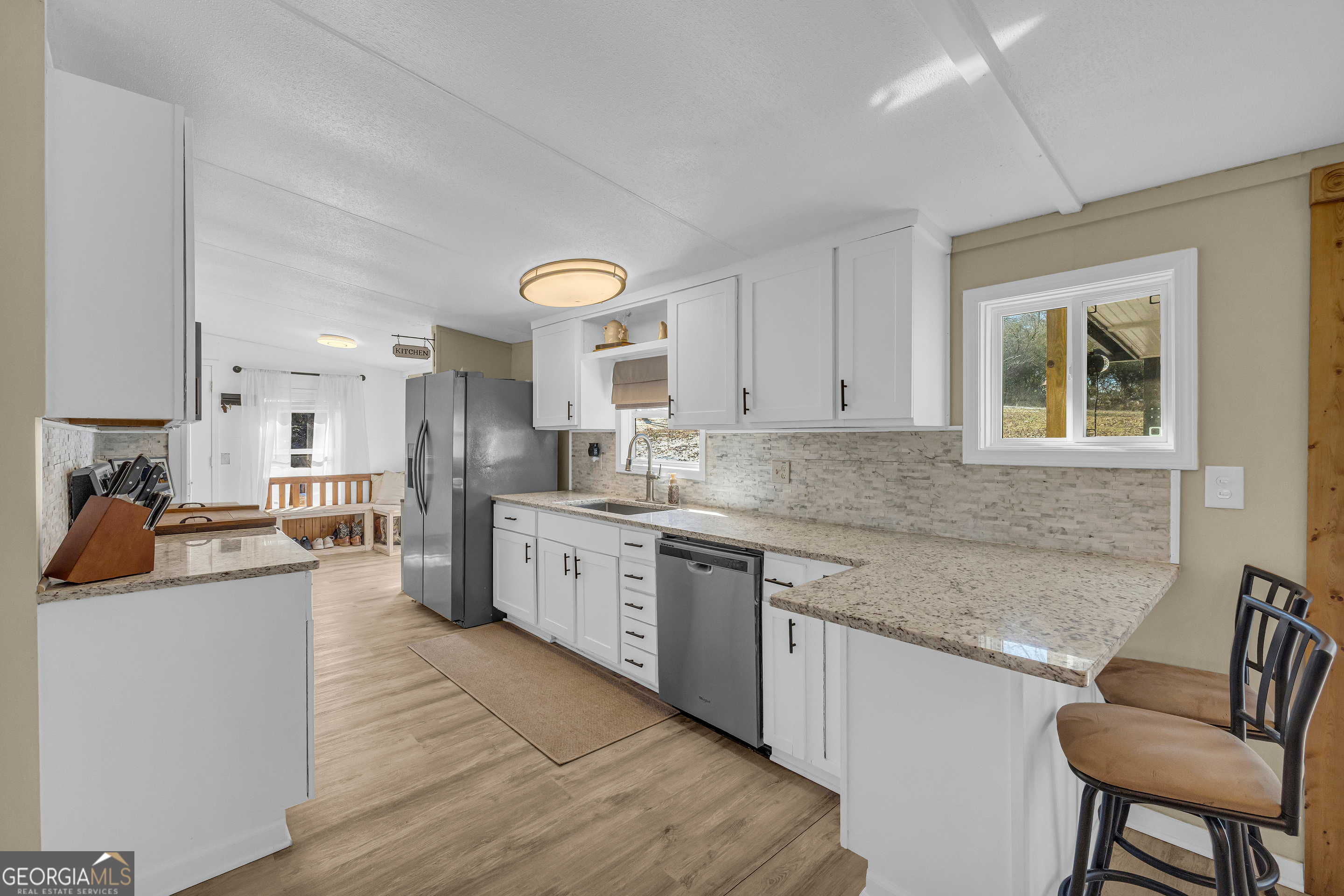 3656 Candler Road Pendergrass, GA 30567 - Photo 20 of 34 a kitchen with stainless steel appliances granite countertop a sink and cabinets