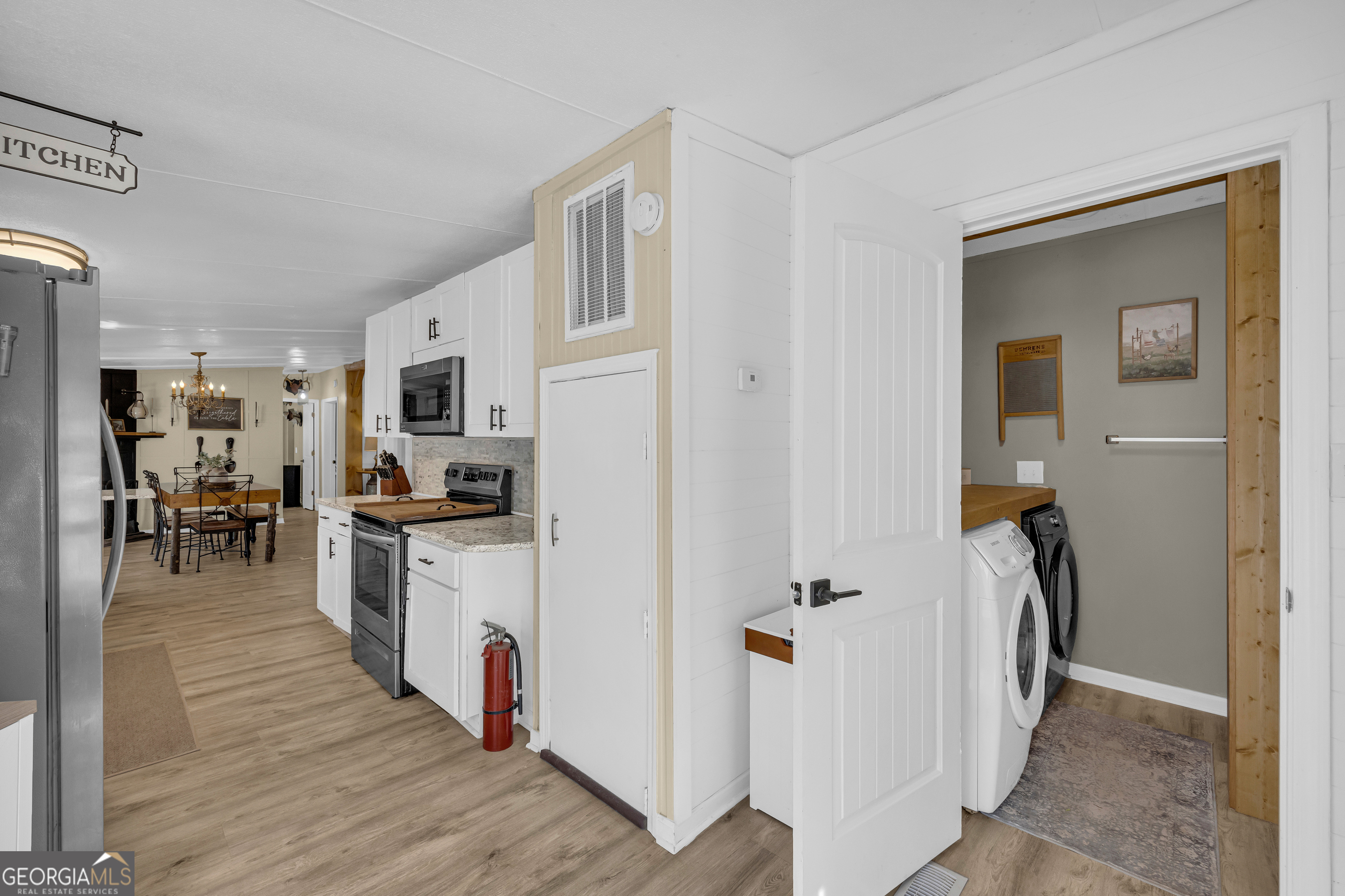 3656 Candler Road Pendergrass, GA 30567 - Photo 26 of 34 a kitchen with stainless steel appliances granite countertop a refrigerator and a stove top oven