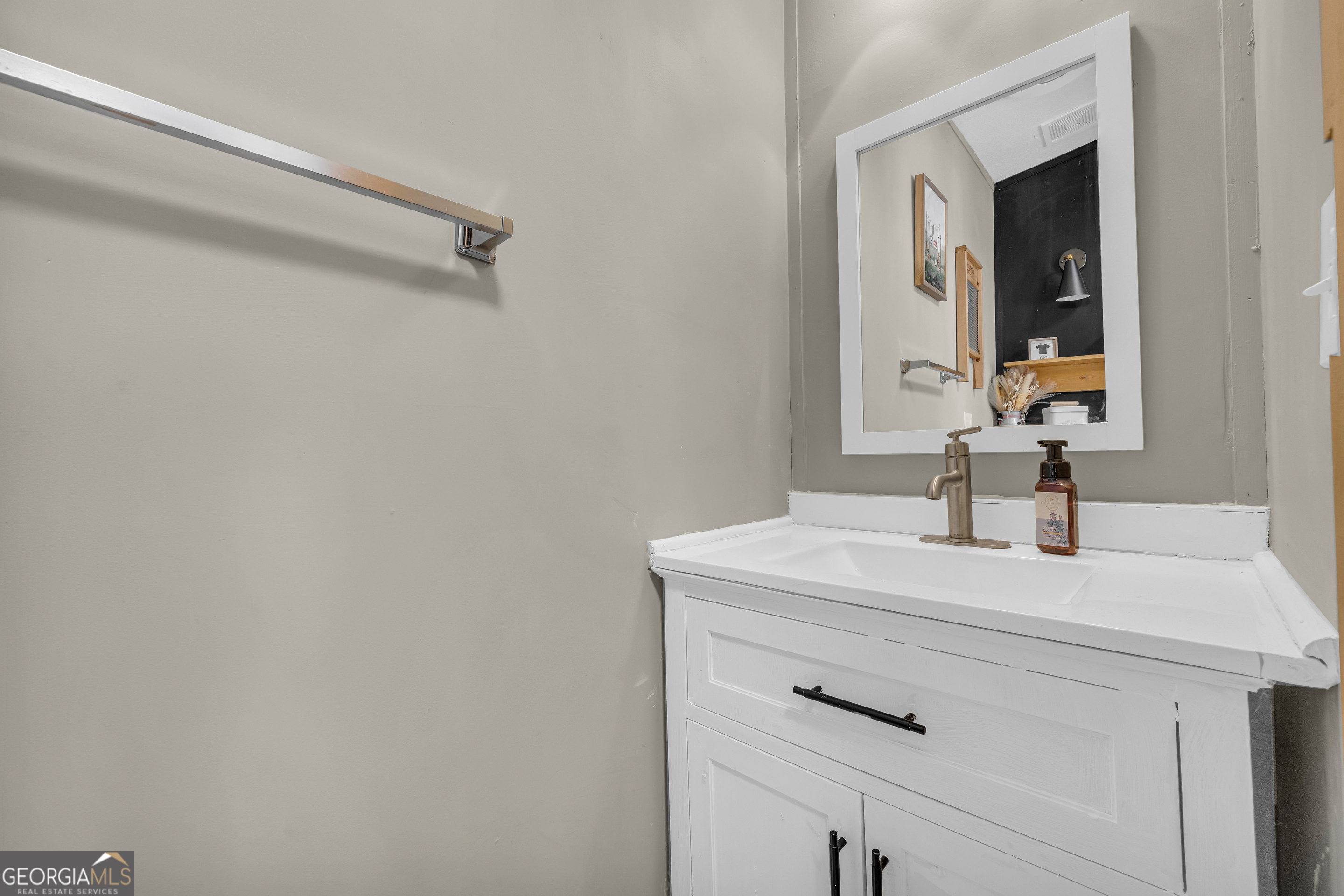 3656 Candler Road Pendergrass, GA 30567 - Photo 28 of 34 a bathroom with a sink vanity and a mirror