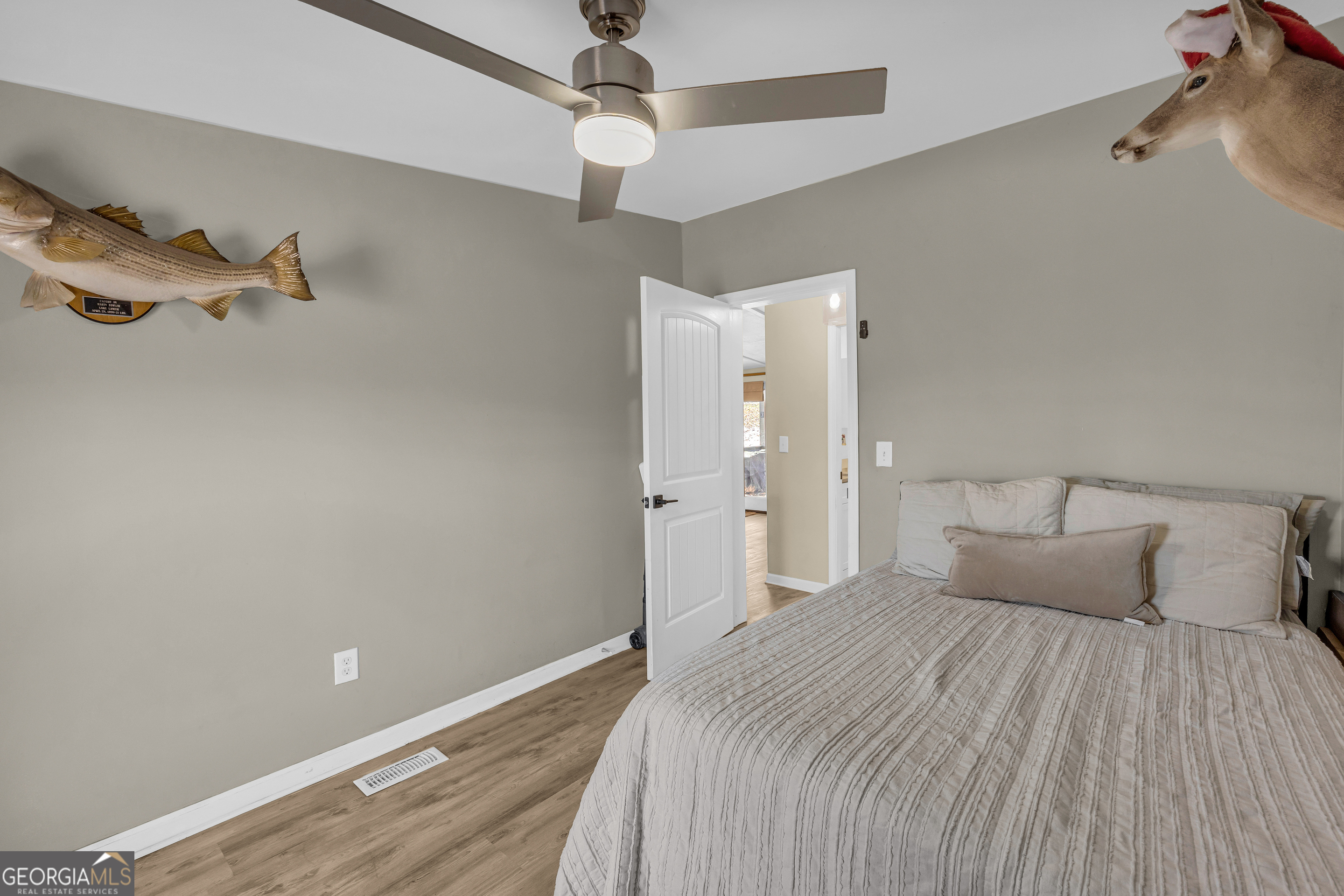 3656 Candler Road Pendergrass, GA 30567 - Photo 32 of 34 a bedroom with a bed and a chandelier