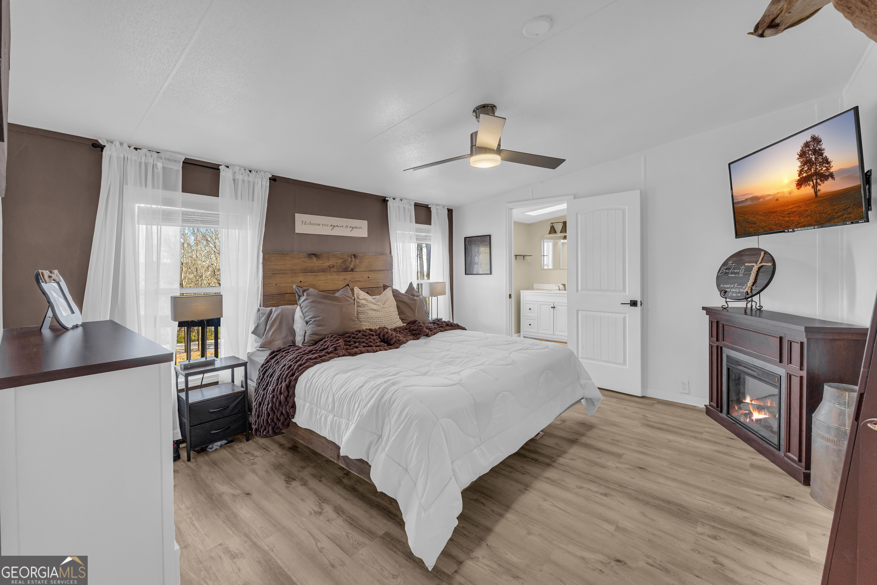 3656 Candler Road Pendergrass, GA 30567 - Photo 9 of 34 a bedroom with a bed and a flat screen tv