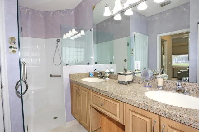 a bathroom with double sink and a mirror