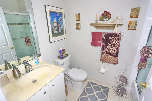 a bathroom with a sink mirror vanity and toilet