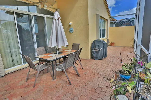 a view of a chairs and table in a patio