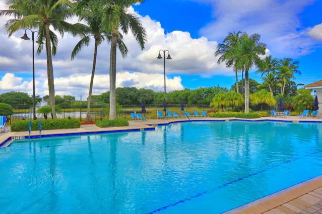 a view of swimming pool with a table and chairs