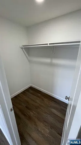 a bathroom with a white toilet sitting next to a white sink and a vanity