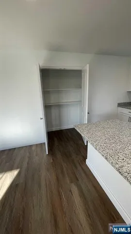 a view of a kitchen counter space and wooden floor