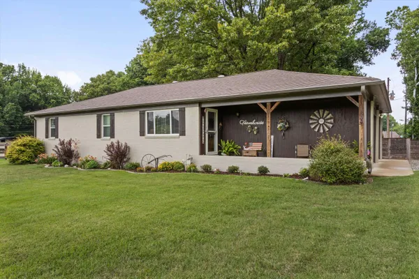 a view of a house with garden and yard