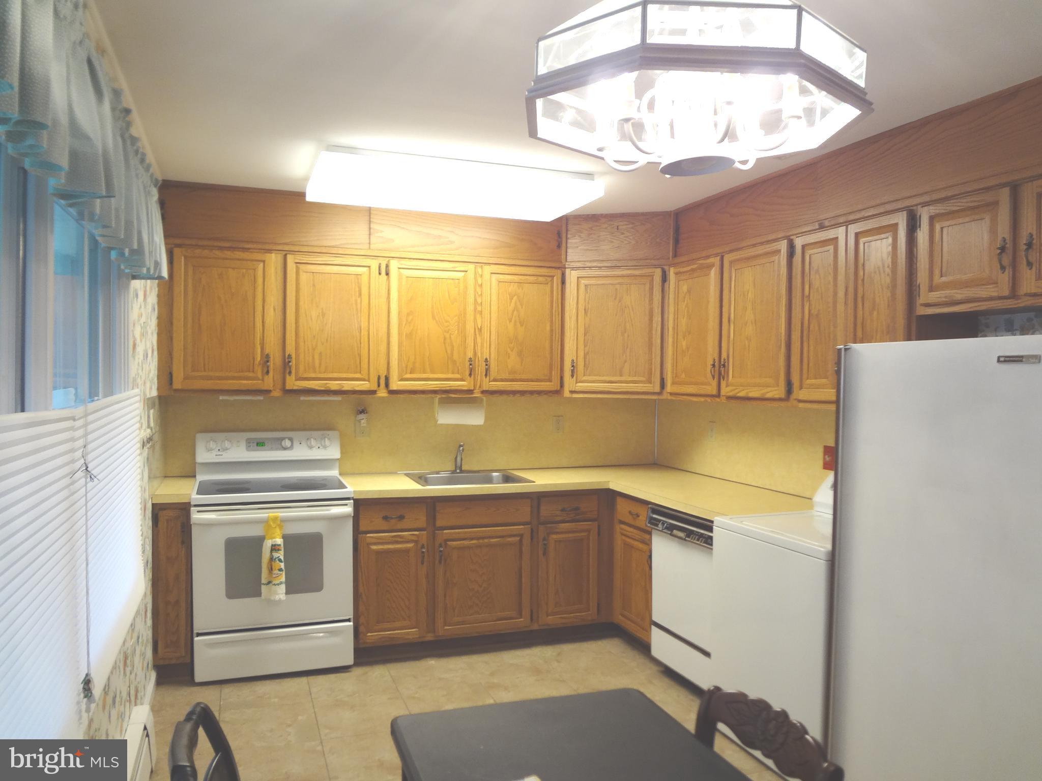 91 Cardinal Road Levittown, PA 19057 - Photo 4 of 26 a kitchen with a sink a stove and cabinets