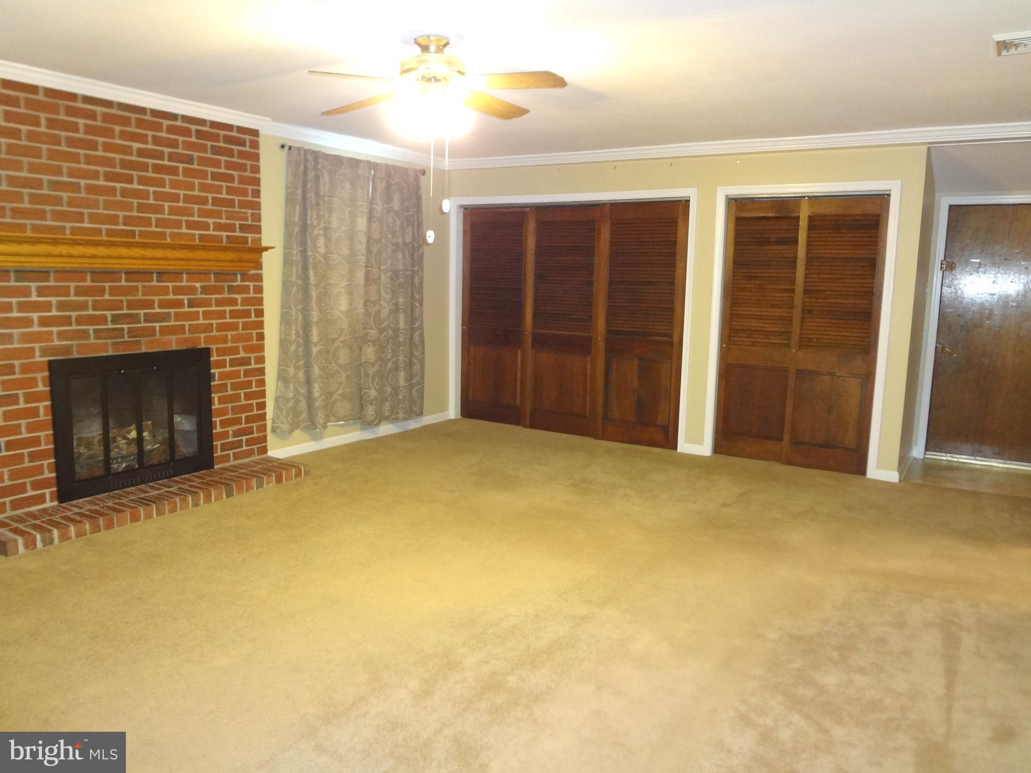 91 Cardinal Road Levittown, PA 19057 - Photo 8 of 26 a view of an empty room with a fireplace