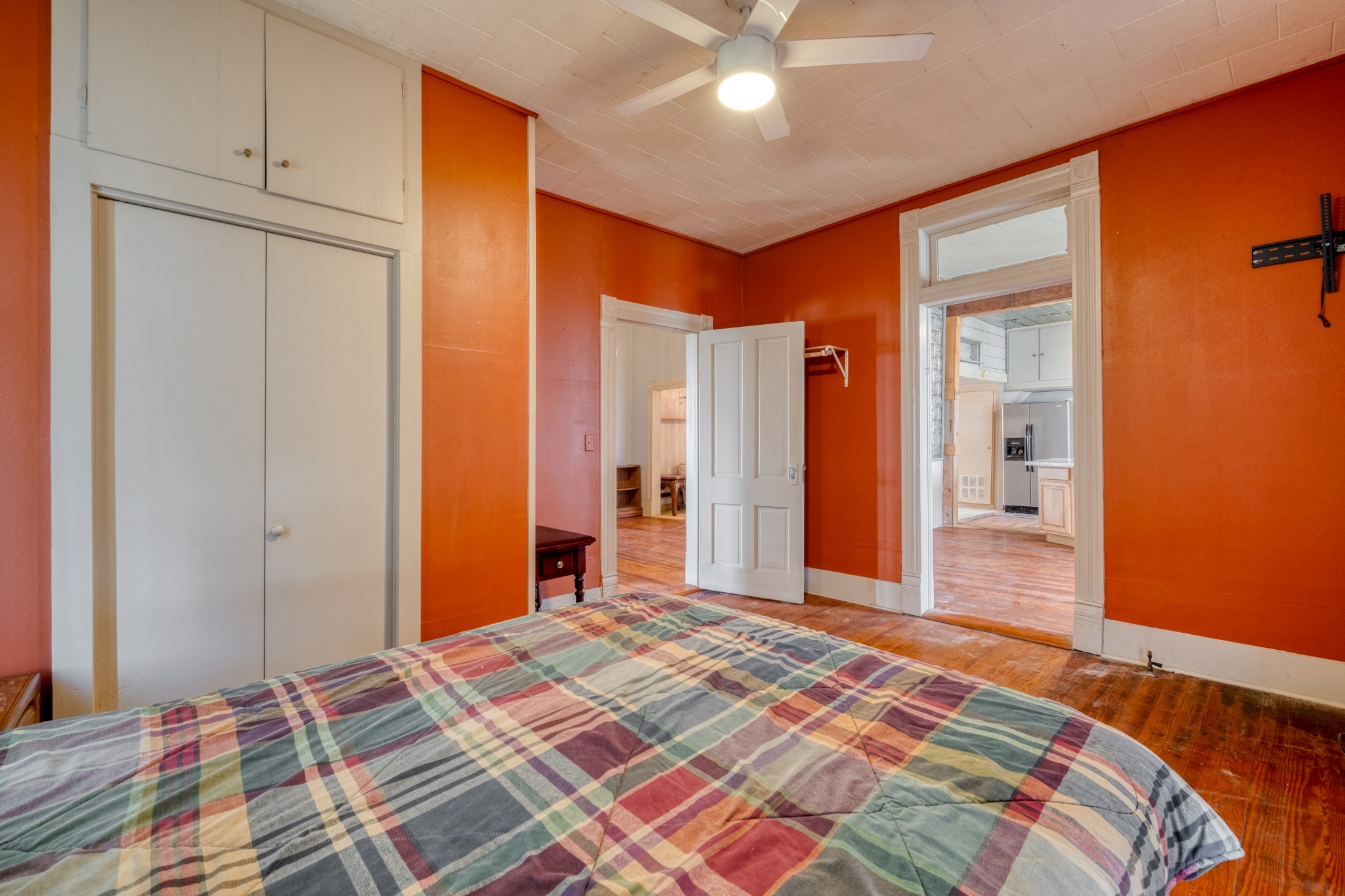 300 South Rio Grande Street Granger, TX 76530 - Photo 16 of 25 Bedroom featuring light wood-style flooring, a closet, a ceiling fan, and stainless steel fridge with ice dispenser