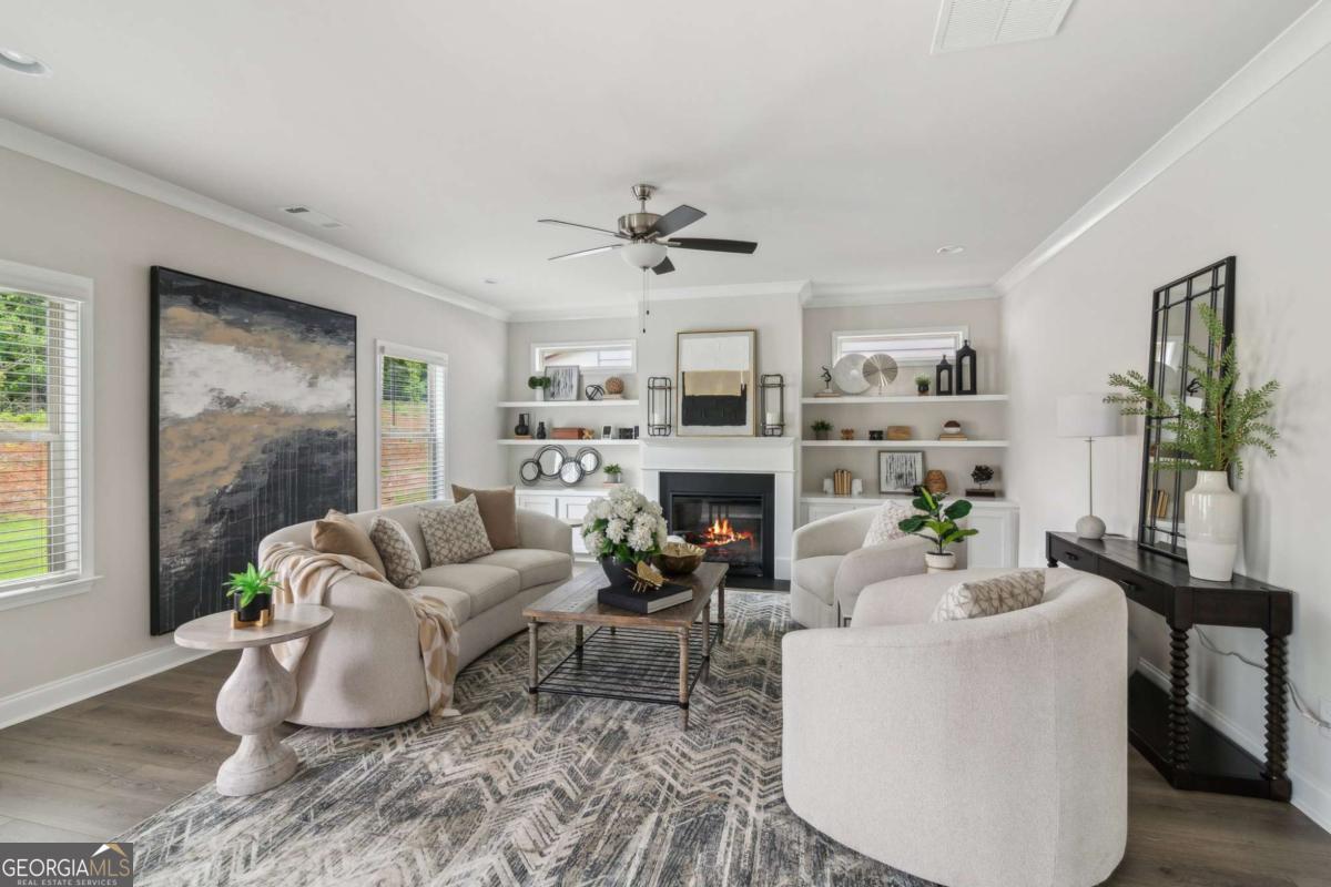 5566 Overview Drive, Unit 25 Flowery Branch, GA 30542 - Photo 11 of 20 a living room with furniture a fireplace and a potted plant