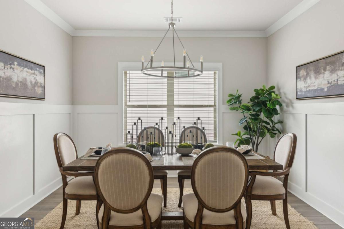 5566 Overview Drive, Unit 25 Flowery Branch, GA 30542 - Photo 13 of 20 a view of a dining room with furniture window and wooden floor