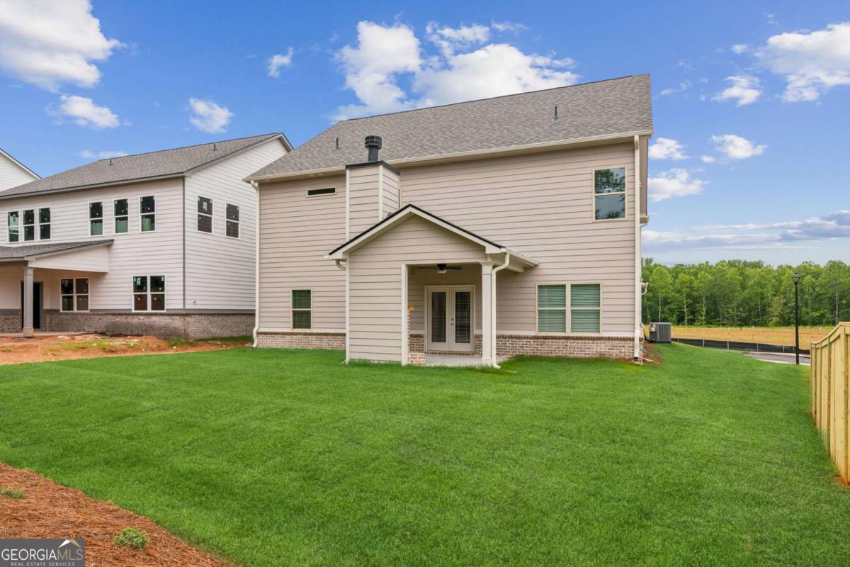 5566 Overview Drive, Unit 25 Flowery Branch, GA 30542 - Photo 20 of 20 a view of a house with a yard