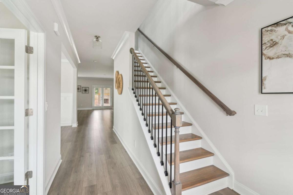 5566 Overview Drive, Unit 25 Flowery Branch, GA 30542 - Photo 2 of 20 a view of a hallway with wooden floor and entryway
