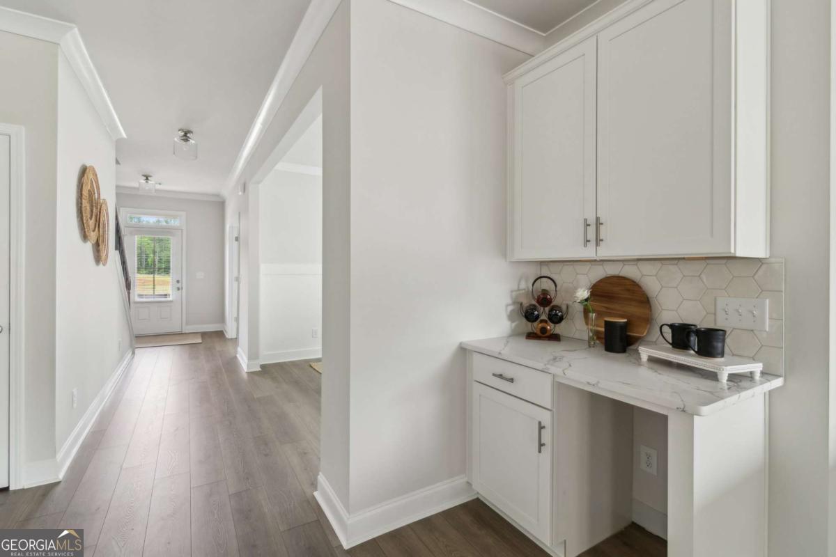 5566 Overview Drive, Unit 25 Flowery Branch, GA 30542 - Photo 6 of 20 a kitchen with stainless steel appliances granite countertop a sink stove and cabinets