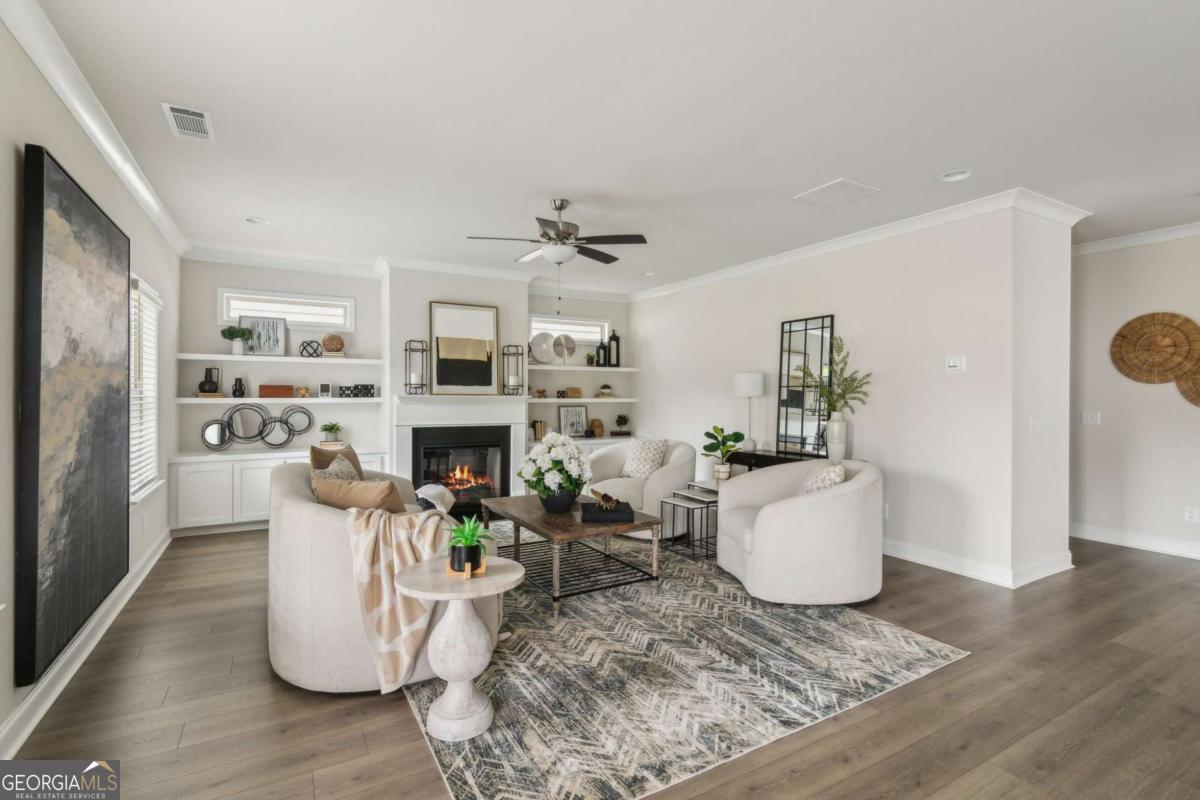 5566 Overview Drive, Unit 25 Flowery Branch, GA 30542 - Photo 10 of 20 a living room with fireplace furniture and a wooden floor