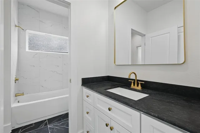 a bathroom with a sink and a bathtub