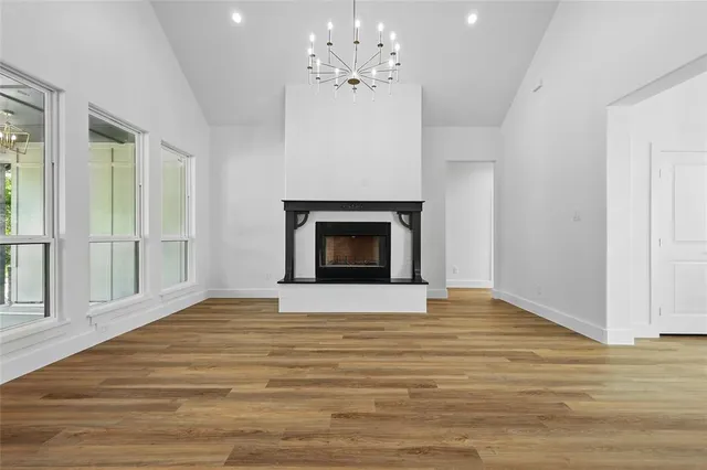 a view of an empty room with a fireplace and a window