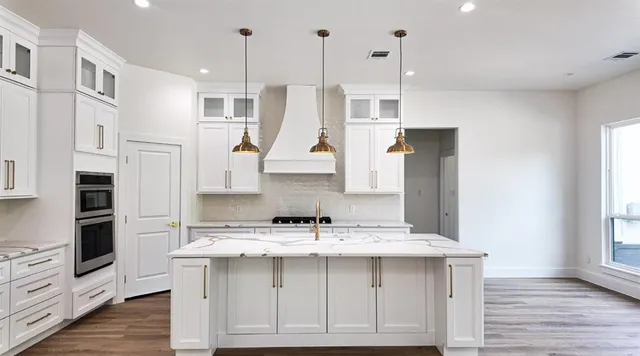 a kitchen with a sink a microwave a refrigerator and wooden floor