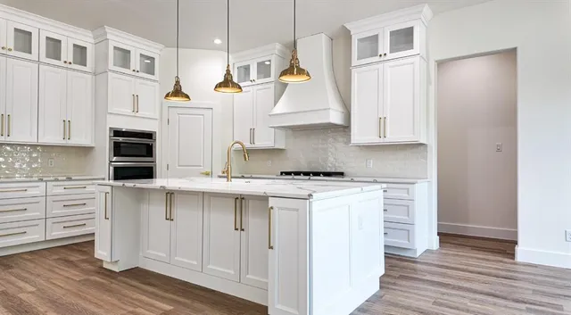 a kitchen with a stove a sink and a refrigerator