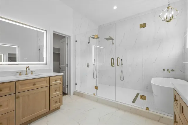 a bathroom with a tub sink toilet and mirror