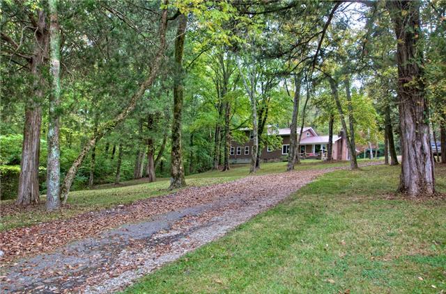 Imagine pulling up this driveway to your home surrounded by these beautiful woods!