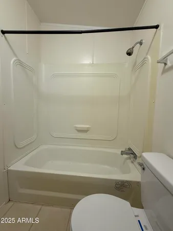 a bathroom with a toilet and a bathtub