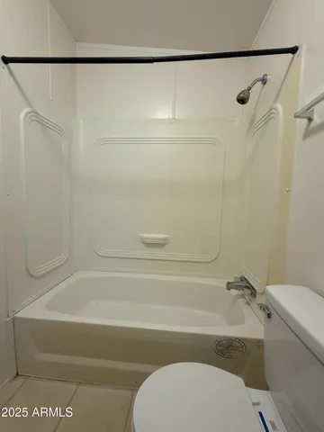 a bathroom with a toilet and a bathtub