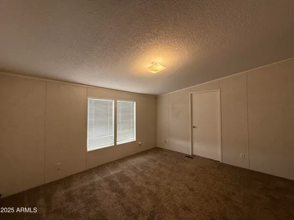 an empty room with a empty space and windows