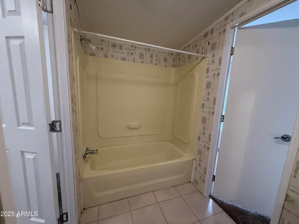 a bathroom with a shower and a bath tub