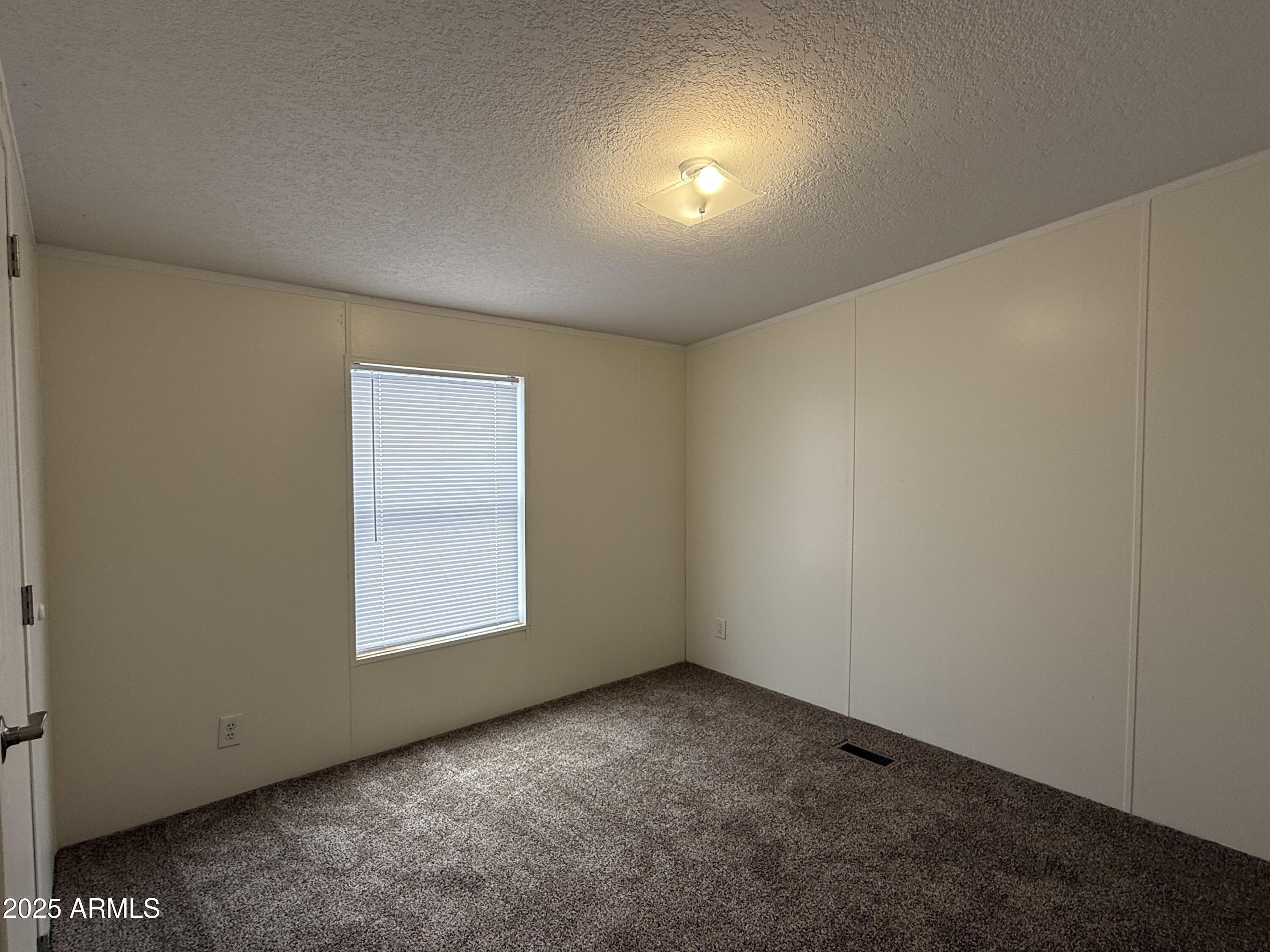 1030 North Hunt Ranch Trail Huachuca City, AZ 85616 - Photo 25 of 28 an empty room with a window