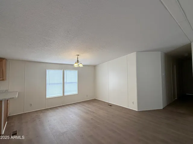 an empty room with windows and entrance