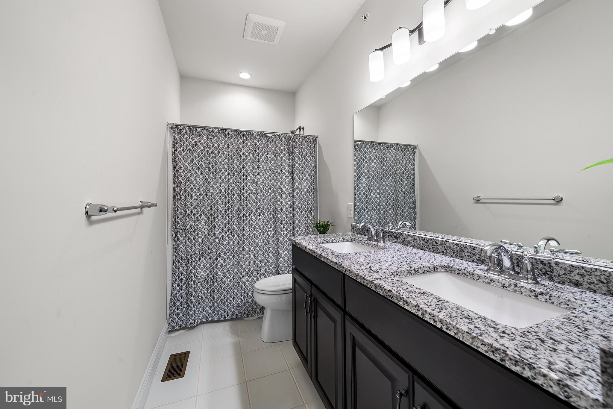 111 Park View Lane Royersford, PA 19468 - Photo 20 of 49 a bathroom with a granite countertop sink a toilet a mirror and shower