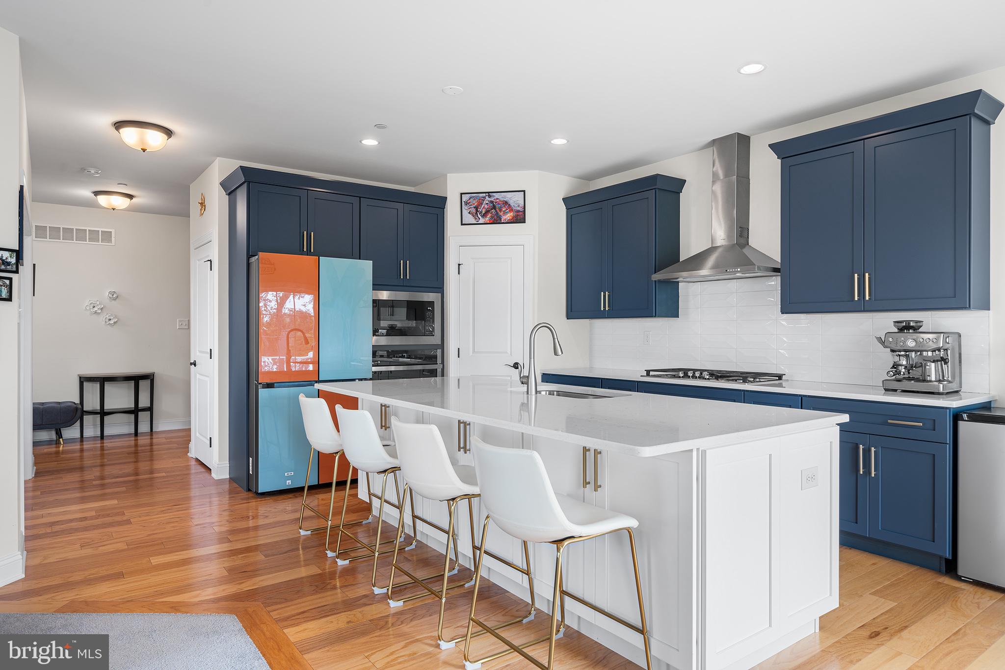 111 Park View Lane Royersford, PA 19468 - Photo 10 of 49 a kitchen with stainless steel appliances granite countertop a stove a sink a refrigerator and white cabinets with wooden floor