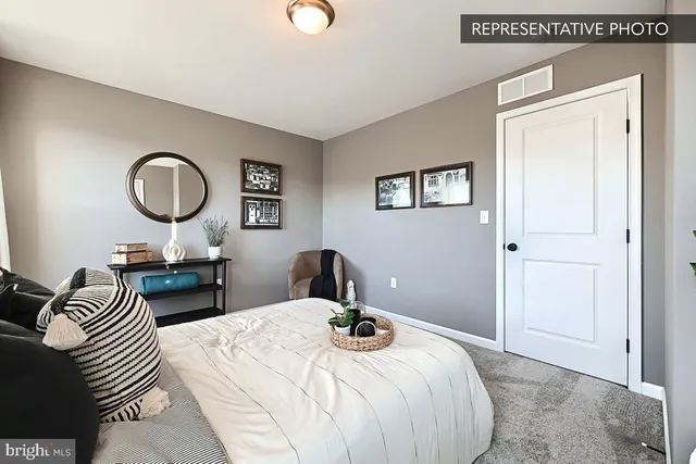 a bedroom with bed and a chandelier