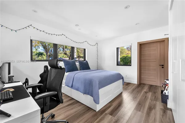 a bedroom with a bed and window